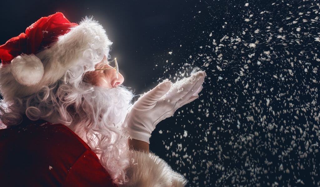Santa blowing snow out of hands.
