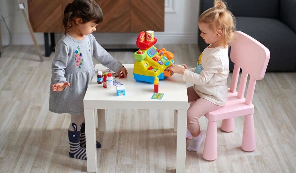 Two children playing shops at a table. Soft play cafes in Northants