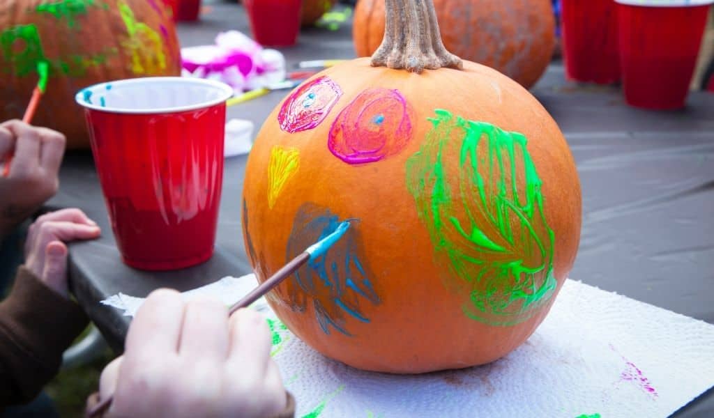 A pumpkin being painted by a child. Northants Families easy halloween kids crafts