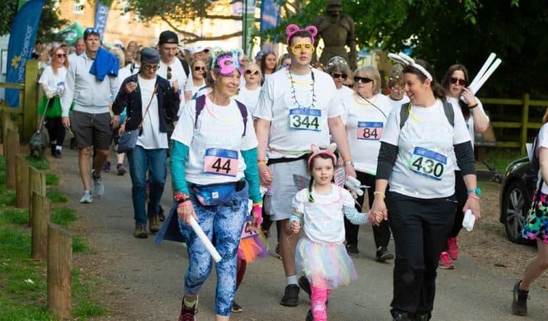 Men, women and children doing a charity walk