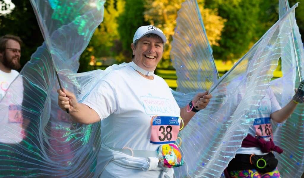 Woman with fake wings doing a charity walk