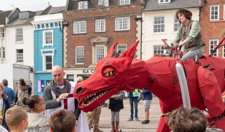 Red dragon with Man on top as part of St Georges Day celebration in Northampton Town
