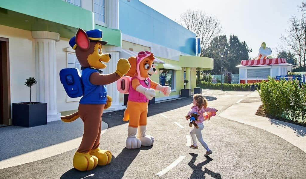 Child running to meet Chase and Skye PAW Patrol characters at Chessington World of Adventures
