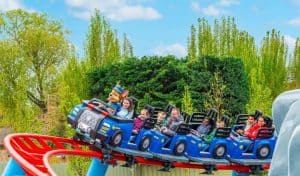 Families riding Chase's Mountain Mission junior roller coaster at World of PAW Patrol Chessington