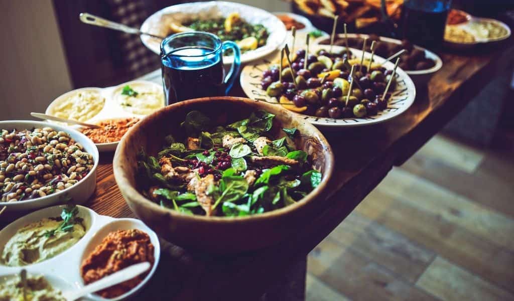 Various tapes type foods laid out on a dark wooden table