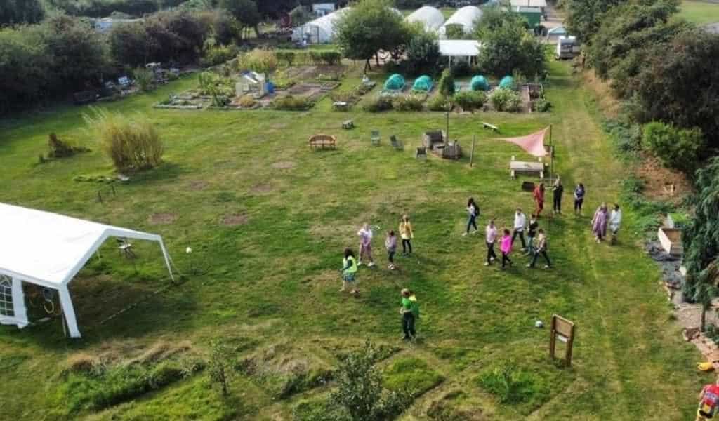 Aerial view of The Green Patch community garden in Kettering, with families and children enjoying the outdoor space