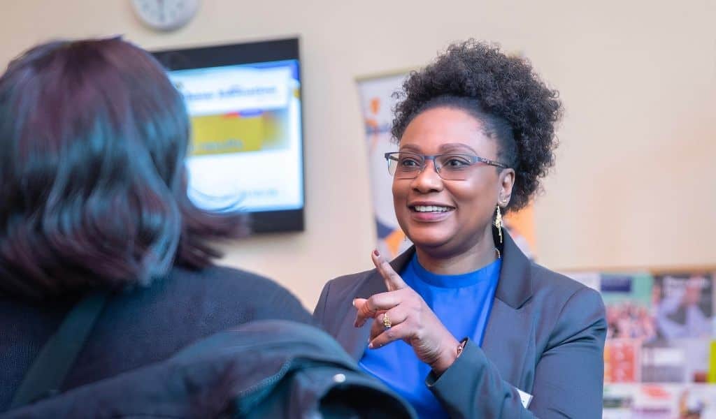 Tutu Alaka, CEO of Bauhaus Education talking to another lady with her back to the camera