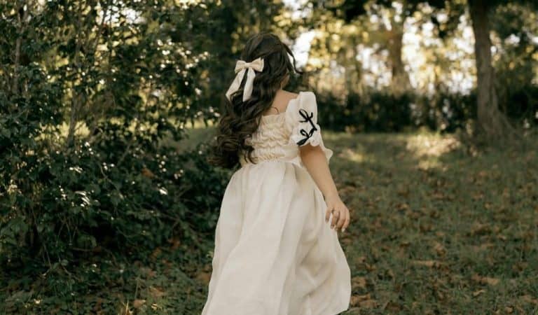 Child Running Through Sunlit Forest Path