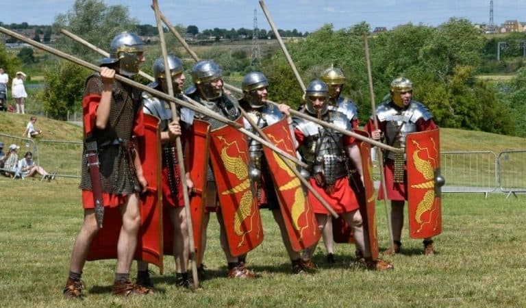 A row of Roman gladiators standing in a field