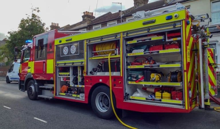 A fire engine with all side cabinets open