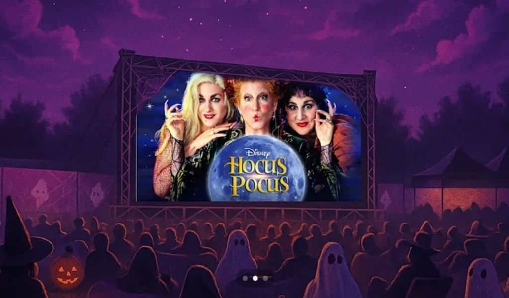 The 3 witches from the Hocus Pocus movies on an outdoor cinema screen in front of an audience of ghoats